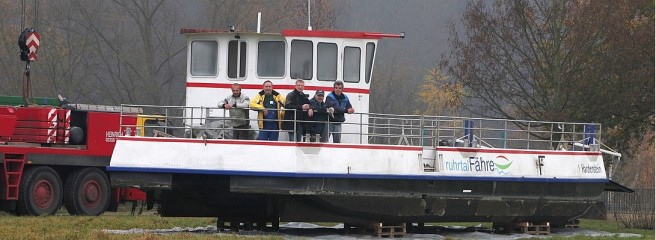 Die Ruhrtalfähre in ihrem „Trockendock“ auf der Wiese am Schleusenwärterhaus. Noch mal an Bord gingen (v.l) Stefan Arendt, Peter Sobotta, Christoph Heemann, Klaus Köster und Michael Sidivopoulos von der Wabe, die sie betreibt. Foto: Fischer / WAZ FotoPool